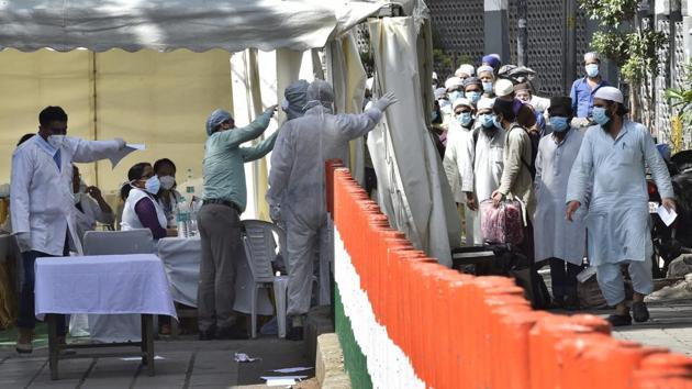 People who took part in a Tablighi Jamaat function earlier this month are checked by a health team before being taken by bus to a quarantine facility amid concerns of infection. (Ajay Aggarwal/HT PHOTO) People who took part in a Tablighi Jamaat function earlier this month are checked by a health team before being taken by bus to a quarantine facility amid concerns of infection. (Ajay Aggarwal/HT PHOTO)