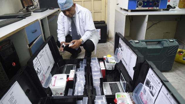 A researcher checks Covid-19 test kits.(AFP) A researcher checks Covid-19 test kits.(AFP)