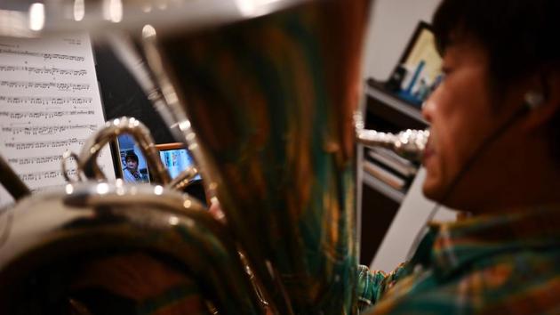 Tuba player Kazuhiko Sato said he was incredulous when the idea of the teleworking orchestra was first floated. “I didn’t think this would work. I felt as if I was being tricked into something,” said Sato, 44. But with all orchestra members stuck at home and concerts cancelled or postponed, this was the only way to make their music heard. (Charly Triballeau / AFP) Tuba player Kazuhiko Sato said he was incredulous when the idea of the teleworking orchestra was first floated. “I didn’t think this would work. I felt as if I was being tricked into something,” said Sato, 44. But with all orchestra members stuck at home and concerts cancelled or postponed, this was the only way to make their music heard. (Charly Triballeau / AFP)