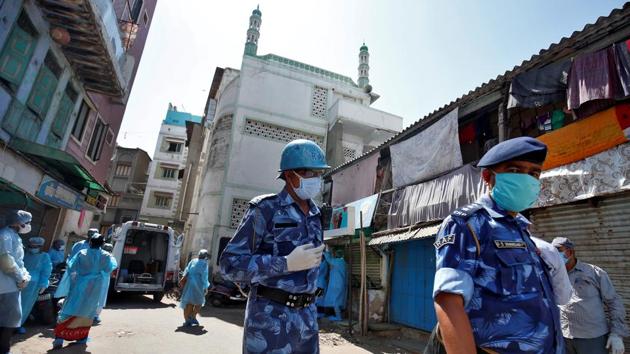 Covid-19 update: Rapid Action Force officers wearing protective masks walk past a mosque from where dozens of men, who according to health and police officials had visited three Muslim missionary gatherings including in Nizamuddin area of New Delhi, were taken to a quarantine facility amid concerns about the spread of coronavirus disease (COVID-19). (REUTERS) Covid-19 update: Rapid Action Force officers wearing protective masks walk past a mosque from where dozens of men, who according to health and police officials had visited three Muslim missionary gatherings including in Nizamuddin area of New Delhi, were taken to a quarantine facility amid concerns about the spread of coronavirus disease (COVID-19). (REUTERS)