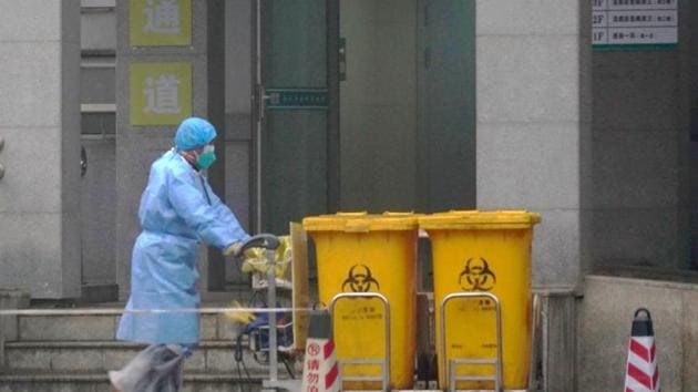 Worker in Wuhan clears biomedical waste.(AP)