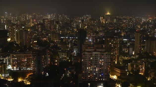 A long view of the skyline in Mumbai’s Borivali suburb, lit by candles, torches and diyas for nine minutes at 9pm in a show of solidarity to fight the coronavirus in India. (Pramod Thakur / HT Photo) 