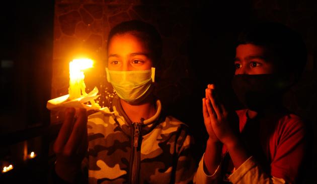 Children hold up candles in solidarity towards the nation's fight against coronavirus in Chandigarh on Sunday, April 05, 2020. (Anil Dayal / HT Photo ) 