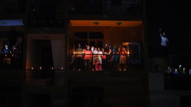 People light lamps, candles and torches at 9pm after Prime Minister Narendra Modi’s appeal to express togetherness against COVID-19, during the nationwide lockdown at Pandav Nagar in New Delhi on Sunday night. (Raj K Raj / HT Photo) 