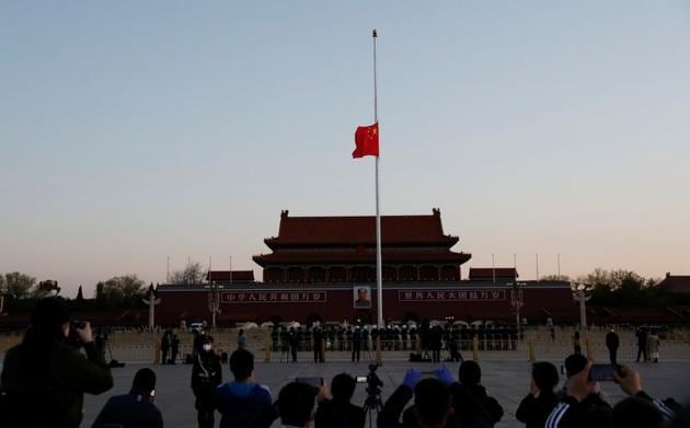 The Chinese national flag flies at half-mast during sunrise at Tiananmen Square in Beijing, as China holds a national mourning for those who died of the coronavirus disease (COVID-19), April 4, 2020. The day of mourning coincided with the start of the annual Qingming tomb-sweeping festival, when millions of Chinese families pay respects to their ancestors. (cnsphoto via REUTERS) The Chinese national flag flies at half-mast during sunrise at Tiananmen Square in Beijing, as China holds a national mourning for those who died of the coronavirus disease (COVID-19), April 4, 2020. The day of mourning coincided with the start of the annual Qingming tomb-sweeping festival, when millions of Chinese families pay respects to their ancestors. (cnsphoto via REUTERS)