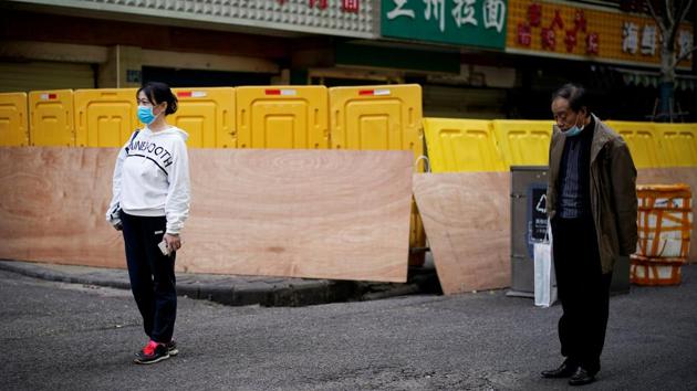 People observe a moment of silence on a street in Wuhan, Hubei province, as China holds a national mourning for those who died of the coronavirus disease (COVID-19), on the Qingming tomb-sweeping festival, April 4, 2020. (Aly Song / REUTERS) People observe a moment of silence on a street in Wuhan, Hubei province, as China holds a national mourning for those who died of the coronavirus disease (COVID-19), on the Qingming tomb-sweeping festival, April 4, 2020. (Aly Song / REUTERS)