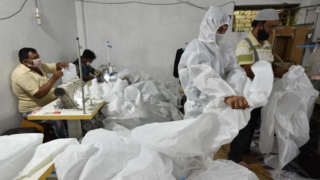 Workers of Maheshtala Bright Tailoring prepare Personal Protective Equipment (PPE) for medical staff at Maheshtala, South 24 Pargana district. (HT photo/Samir Jana) Workers of Maheshtala Bright Tailoring prepare Personal Protective Equipment (PPE) for medical staff at Maheshtala, South 24 Pargana district. (HT photo/Samir Jana)