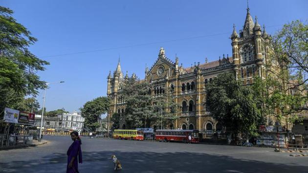 A woman walks near the Chhatrapati Shivaji Maharaj Terminus (CSMT) during a lockdown imposed due to the coronavirus in Mumbai.(Bloomberg) A woman walks near the Chhatrapati Shivaji Maharaj Terminus (CSMT) during a lockdown imposed due to the coronavirus in Mumbai.(Bloomberg)