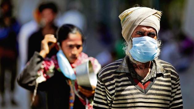 People wearing face masks queue for food inside a shelter in New Delhi (Reuters) People wearing face masks queue for food inside a shelter in New Delhi (Reuters)