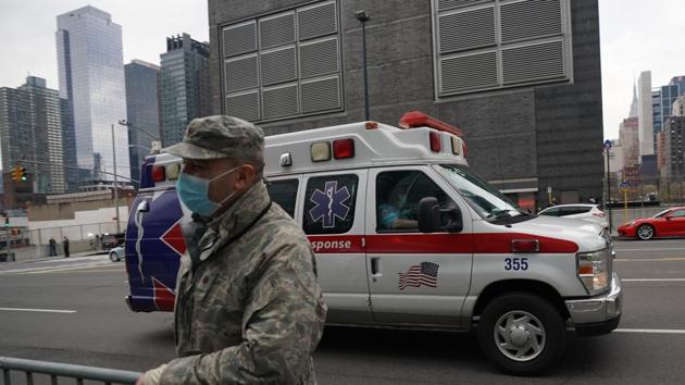 An ambulance drives by a US Army National Guards member standing outside of the Jacob K Javits Centre on April 5 in New York. The Covid-19 death toll in New York state spiked to 4,159, the governor said, up from 3,565 a day prior. (AFP Photo) An ambulance drives by a US Army National Guards member standing outside of the Jacob K Javits Centre on April 5 in New York. The Covid-19 death toll in New York state spiked to 4,159, the governor said, up from 3,565 a day prior. (AFP Photo)