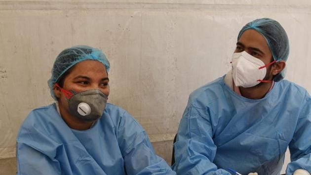 Doctors check patients for symptoms of coronavirus before they are allowed to enter the main building at Maulana Azad Hospital in New Delhi, India, on Wednesday. (Sanchit Khanna/HT PHOTO) Doctors check patients for symptoms of coronavirus before they are allowed to enter the main building at Maulana Azad Hospital in New Delhi, India, on Wednesday. (Sanchit Khanna/HT PHOTO)