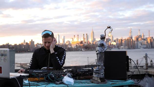 DJ and event producer Nash Petrovic live streams a set from his roof in Brooklyn, New York. (Caitlin Ochs / REUTERS)