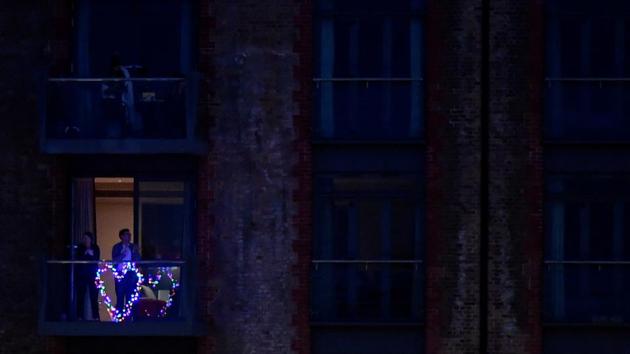 People applaud from their balconies during the ‘Clap for our Carers’ campaign in support of NHS workers in London. (Toby Melville / REUTERS)