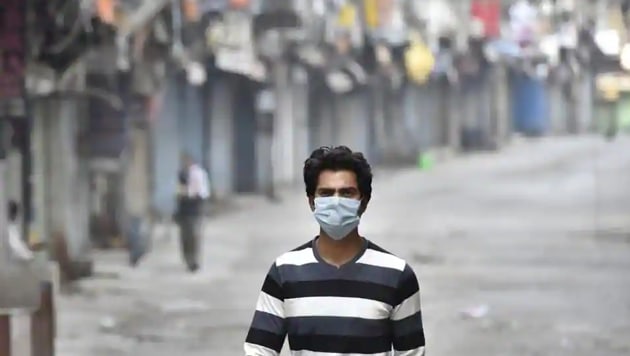 A man wearing a face mask out walking in the Sadar Bazaar market while shops remain shuttered, on day fourteen of the 21 day nationwide lockdown to check the spread of coronavirus. (HT Photo) A man wearing a face mask out walking in the Sadar Bazaar market while shops remain shuttered, on day fourteen of the 21 day nationwide lockdown to check the spread of coronavirus. (HT Photo)