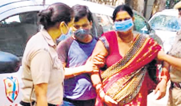 A pregnant woman being assisted by a Delhi Police personnel.