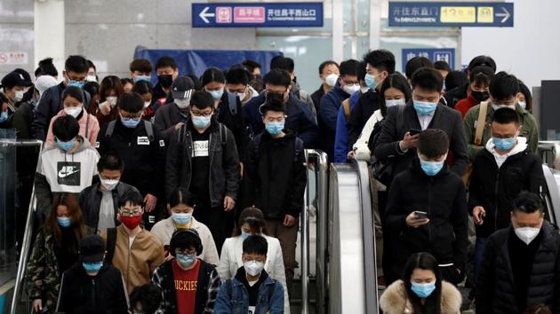 People wearing face masks stand on an escalator inside a subway station during morning rush hour in Beijing, on April 7.(Reuters Photo) People wearing face masks stand on an escalator inside a subway station during morning rush hour in Beijing, on April 7.(Reuters Photo)