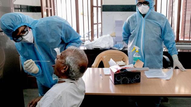 Medics collect swab from a person for COVID-19 test as part of a drive to control the spread of the new coronavirus, in Madanpura area Mumbai, Tuesday, April 7, 2020.(PTI)