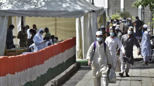 New Delhi, India - March 31, 2020: People who took part in a Tablighi Jamaat function earlier this month walk to board buses that will take them to a quarantine facility amid concerns of infection, on day 7 of the 21 day nationwide lockdown imposed by PM Narendra Modi to check the spread of coronavirus, at Nizamuddin West in New Delhi, India, on Tuesday, March 31, 2020. (Photo by Ajay Aggarwal/ Hindustan Times) (Ajay Aggarwal/HT PHOTO) New Delhi, India - March 31, 2020: People who took part in a Tablighi Jamaat function earlier this month walk to board buses that will take them to a quarantine facility amid concerns of infection, on day 7 of the 21 day nationwide lockdown imposed by PM Narendra Modi to check the spread of coronavirus, at Nizamuddin West in New Delhi, India, on Tuesday, March 31, 2020. (Photo by Ajay Aggarwal/ Hindustan Times) (Ajay Aggarwal/HT PHOTO)