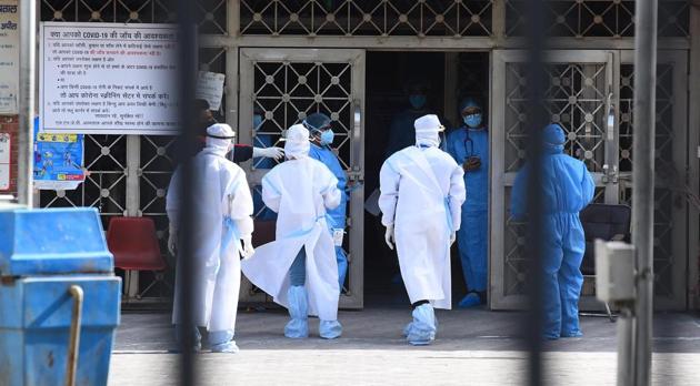Doctors and other medical staff seen in PPE after a group of people suspected of Covid-19 infection were brought in LNJP hospital on day fourteen of the 21 day nationwide lockdown to curb the spread of coronavirus. (Raj K Raj/HT photo) Doctors and other medical staff seen in PPE after a group of people suspected of Covid-19 infection were brought in LNJP hospital on day fourteen of the 21 day nationwide lockdown to curb the spread of coronavirus. (Raj K Raj/HT photo)