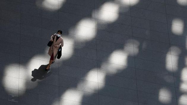 A woman walks in an almost empty convention centre in Tokyo. The imposed state of emergency comes with no penalties for ignoring the requests in most cases. However, enforcement will rely largely on societal pressure and respect for authority. (Issei Kato / REUTERS) A woman walks in an almost empty convention centre in Tokyo. The imposed state of emergency comes with no penalties for ignoring the requests in most cases. However, enforcement will rely largely on societal pressure and respect for authority. (Issei Kato / REUTERS)