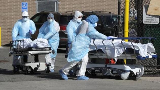 Healthcare workers wheel the bodies of deceased people outside the Wyckoff Heights Medical Center during the outbreak of the coronavirus disease in the Brooklyn borough of New York City.(Reuters File Photo)