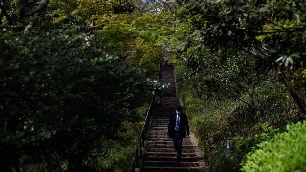 A man in a Tokyo park on April 6. Prime Minister Shinzo Abe urged people to curb social contact by 70-80%. (Philip Fong / AFP) A man in a Tokyo park on April 6. Prime Minister Shinzo Abe urged people to curb social contact by 70-80%. (Philip Fong / AFP)