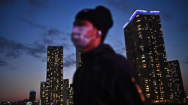 A man wearing a face mask walks along a promenade in Tokyo on April 7. Prime Minister Shinzo Abe told a televised news conference that a recent rise in Covid-19 cases in Tokyo and other urban areas had forced him to rethink Japan’s approach towards handling the outbreak. (Philip Fong / AFP) A man wearing a face mask walks along a promenade in Tokyo on April 7. Prime Minister Shinzo Abe told a televised news conference that a recent rise in Covid-19 cases in Tokyo and other urban areas had forced him to rethink Japan’s approach towards handling the outbreak. (Philip Fong / AFP)