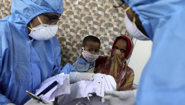Doctors interact with people at a slum area during lockdown to control the spread of the new coronavirus in Mumbai, India, Monday, April 6, 2020. The new coronavirus causes mild or moderate symptoms for most people, but for some, especially older adults and people with existing health problems, it can cause more severe illness or death. (AP) Doctors interact with people at a slum area during lockdown to control the spread of the new coronavirus in Mumbai, India, Monday, April 6, 2020. The new coronavirus causes mild or moderate symptoms for most people, but for some, especially older adults and people with existing health problems, it can cause more severe illness or death. (AP)