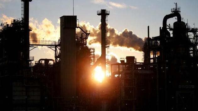 Smoke rises from a factory during sunset at Keihin industrial zone in Kawasaki, Japan.(REUTERS)