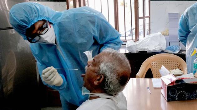 Medics collect swab from a person for Covid-19 test as part of a drive to control the spread of the novel coronavirus in Madanpura area, Mumbai.(PTI Photo)