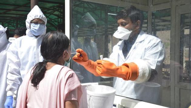 People have samples taken at a coronavirus sample collection centre inaugurated by Chief Development Officer (CDO) Asmita Lal, on day fourteen of the 21 day nationwide lockdown to check the spread of coronavirus, at District hospital Sanjay Nagar in Ghaziabad. (Photo by Sakib Ali /Hindustan Times) People have samples taken at a coronavirus sample collection centre inaugurated by Chief Development Officer (CDO) Asmita Lal, on day fourteen of the 21 day nationwide lockdown to check the spread of coronavirus, at District hospital Sanjay Nagar in Ghaziabad. (Photo by Sakib Ali /Hindustan Times)