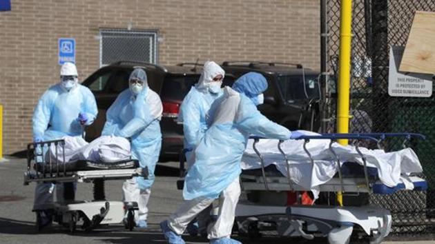 Healthcare workers wheel the bodies of deceased people during the outbreak of the coronavirus disease (COVID-19) in the Brooklyn borough of New York City, New York, US, April 6, 2020.(REUTERS)