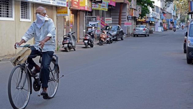 A cyclist riding on the deserted road in Sadashiv peth area on Tuesday. (RAVINDRA JOSHI/HT) A cyclist riding on the deserted road in Sadashiv peth area on Tuesday. (RAVINDRA JOSHI/HT)