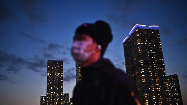 A man wearing a face mask walks along a promenade in Tokyo amid coronavirus outbreak. (AFP) A man wearing a face mask walks along a promenade in Tokyo amid coronavirus outbreak. (AFP)
