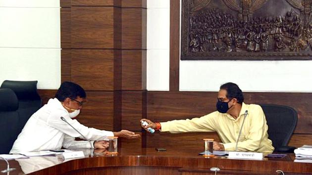 Maharashtra CM Uddhav Thackeray gives hand sanitiser to a minister as he chairs a cabinet meeting via video conference, on Tuesday. (ANI Photo) Maharashtra CM Uddhav Thackeray gives hand sanitiser to a minister as he chairs a cabinet meeting via video conference, on Tuesday. (ANI Photo)