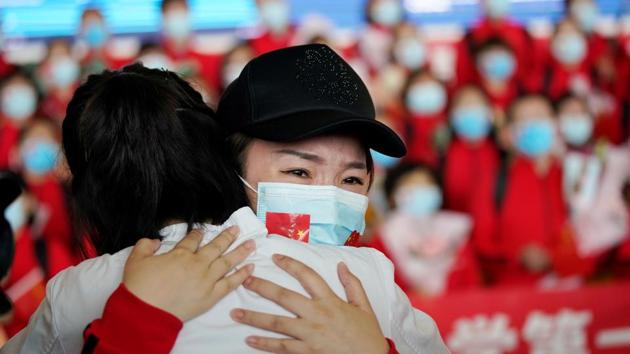 A member of a medical team in an emotional moment at the Wuhan Tianhe International Airport, April 8. The city of 11 million had accounted for a vast majority of Covid-19 cases in China with more than 50,000 infected and 2,572 killed. (Aly Song / REUTERS) A member of a medical team in an emotional moment at the Wuhan Tianhe International Airport, April 8. The city of 11 million had accounted for a vast majority of Covid-19 cases in China with more than 50,000 infected and 2,572 killed. (Aly Song / REUTERS)