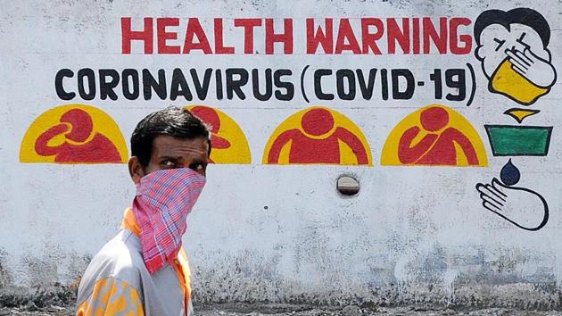 A man wearing a protective mask walks past a walking graffiti during a nationwide lockdown imposed in the wake of coronavirus pandemic, in Mumbai. (ANI) A man wearing a protective mask walks past a walking graffiti during a nationwide lockdown imposed in the wake of coronavirus pandemic, in Mumbai. (ANI)
