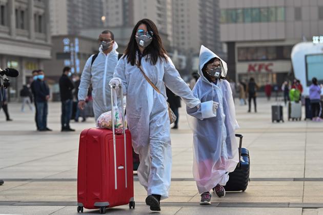 People wearing protective clothing and masks arrive at Hankou Railway Station in Wuhan, to board one of the first trains leaving the city in China's central Hubei province early on April 8, 2020. -Chinese authorities lifted a more than two-month ban on outbound travel from the city where the global pandemic first emerged. (AFP) People wearing protective clothing and masks arrive at Hankou Railway Station in Wuhan, to board one of the first trains leaving the city in China's central Hubei province early on April 8, 2020. -Chinese authorities lifted a more than two-month ban on outbound travel from the city where the global pandemic first emerged. (AFP)