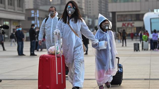 People wearing protective clothing and masks arrive at Hankou Railway Station in Wuhan to board one of the first trains leaving the city in China's central Hubei province early on April 8, 2020. (Hector Retamal / AFP) People wearing protective clothing and masks arrive at Hankou Railway Station in Wuhan to board one of the first trains leaving the city in China's central Hubei province early on April 8, 2020. (Hector Retamal / AFP)