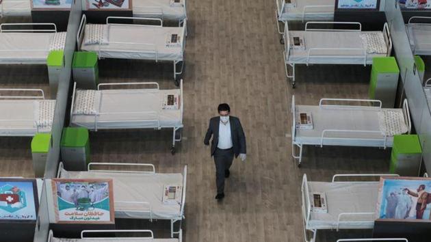 A man walks between beds at a shopping mall, one of Iran’s largest, which has been turned into a centre to receive patients suffering from the coronavirus disease (COVID-19), in Tehran. (REUTERS) A man walks between beds at a shopping mall, one of Iran’s largest, which has been turned into a centre to receive patients suffering from the coronavirus disease (COVID-19), in Tehran. (REUTERS)