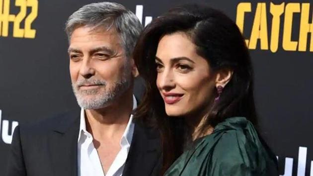 George Clooney poses with wife Amal at the premiere of his show Catch-22.