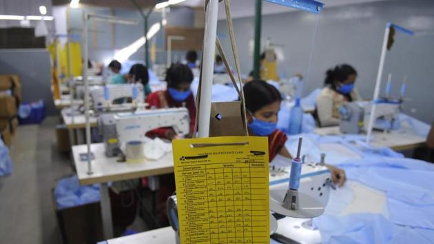 Protective suits for medical use being produced at a factory, in Noida.(Sunil Ghosh / Hindustan Times)
