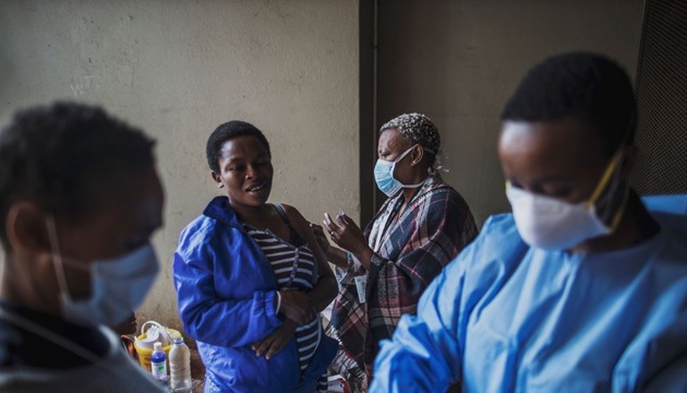 A person reacts as she receives a flu vaccine while a Gauteng Health Department Official gets ready before collecting samples during a door-to-door coronavirus testing drive in Yeoville, Johannesburg, on April 3.(AFP via Getty Images)