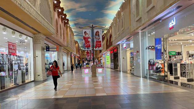 A woman walks in an almost empty mall amid the outbreak of coronavirus in Dubai.(REUTERS)
