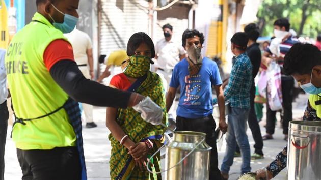 People at a food distribution by the Delhi government at Laxmi Nagar, on day fifteen of the 21-day nationwide lockdown to check the spread of coronavirus, in New Delhi. (Raj K Raj/HT PHOTO) People at a food distribution by the Delhi government at Laxmi Nagar, on day fifteen of the 21-day nationwide lockdown to check the spread of coronavirus, in New Delhi. (Raj K Raj/HT PHOTO)