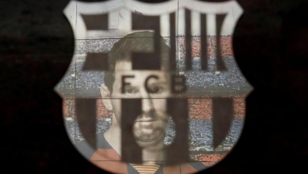 A picture of Lionel Messi is reflected in the Barcelona emblem outside the stadium (REUTERS) A picture of Lionel Messi is reflected in the Barcelona emblem outside the stadium (REUTERS)