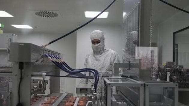 Wearing a protective suit, a research and development company worker overseas the production of coronavirus testing kits in Gebze, northwestern Turkey, Monday, March 23, 2020. (AP) Wearing a protective suit, a research and development company worker overseas the production of coronavirus testing kits in Gebze, northwestern Turkey, Monday, March 23, 2020. (AP)