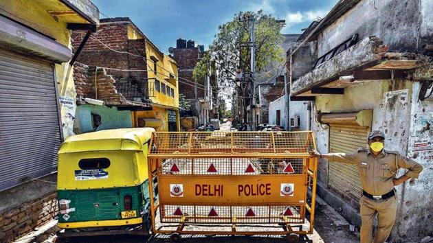 A policeman stands guard outside Gali No 6 , L 1 Sangam Vihar-- one of the twenty hotspot areas sealed to curb the spread of coronavirus, on day sixteen of the 21-day nationwide lockdown, in New Delhi, India, on Thursday, April 9, 2020. (Photo by Biplov Bhuyan/ Hindustan Times) A policeman stands guard outside Gali No 6 , L 1 Sangam Vihar-- one of the twenty hotspot areas sealed to curb the spread of coronavirus, on day sixteen of the 21-day nationwide lockdown, in New Delhi, India, on Thursday, April 9, 2020. (Photo by Biplov Bhuyan/ Hindustan Times)