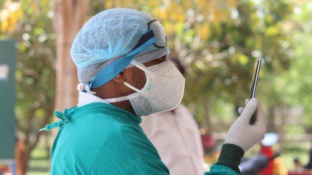 A doctor wearing protective face mask and hairnet at a Covid-19 help desk at Civil Hospital in Gurugram. (Yogendra Kumar/HT Photo) A doctor wearing protective face mask and hairnet at a Covid-19 help desk at Civil Hospital in Gurugram. (Yogendra Kumar/HT Photo)