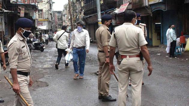 Bhopal: Residents carry household items after purchasing from a market as police maintain security during the complete nationwide lockdown and curfew in the wake of coronavirus pandemic, in Bhopal, Friday, March 27, 2020. (PTI) Bhopal: Residents carry household items after purchasing from a market as police maintain security during the complete nationwide lockdown and curfew in the wake of coronavirus pandemic, in Bhopal, Friday, March 27, 2020. (PTI)